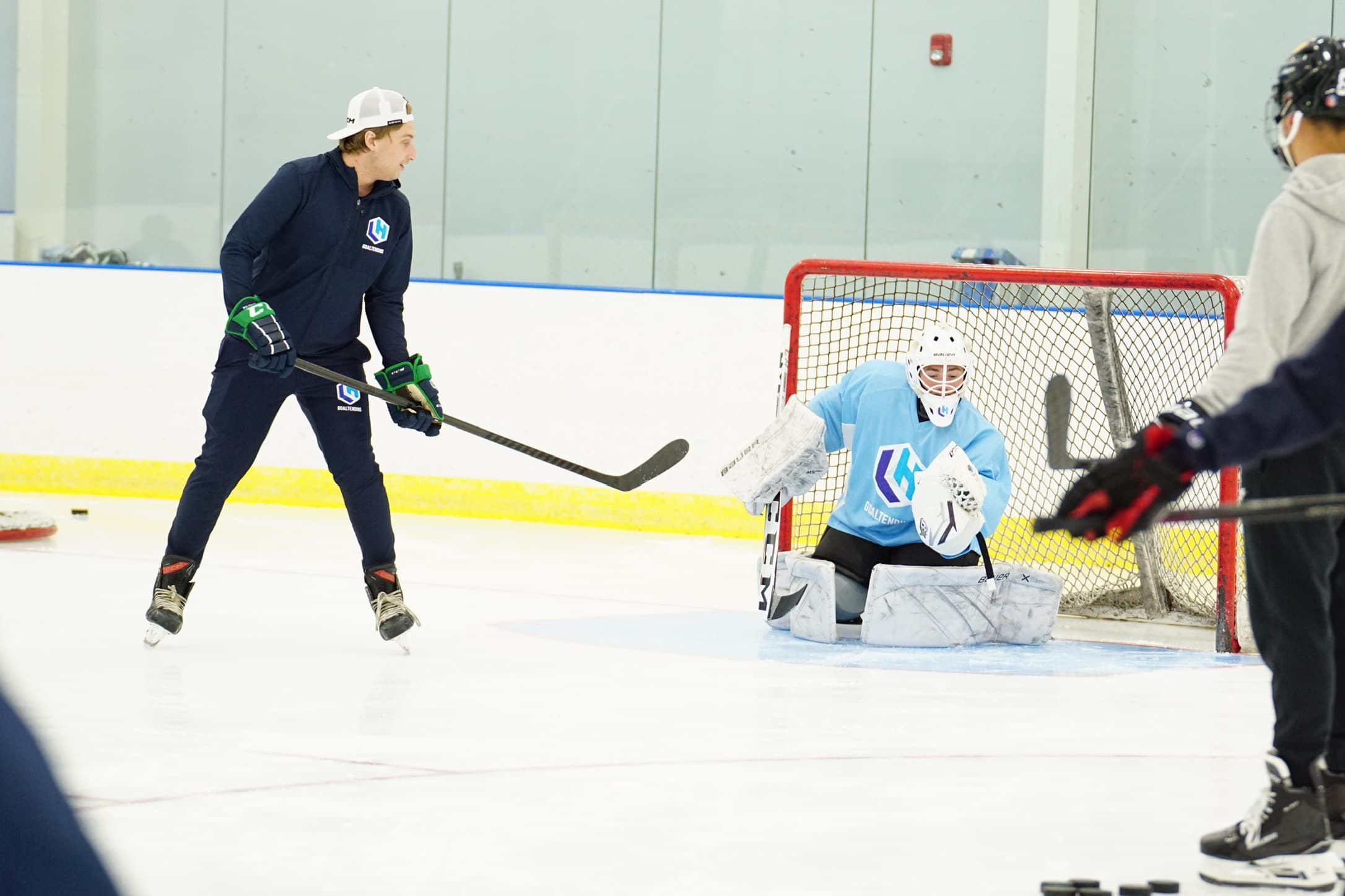 Lucas coaching a goalie at the net