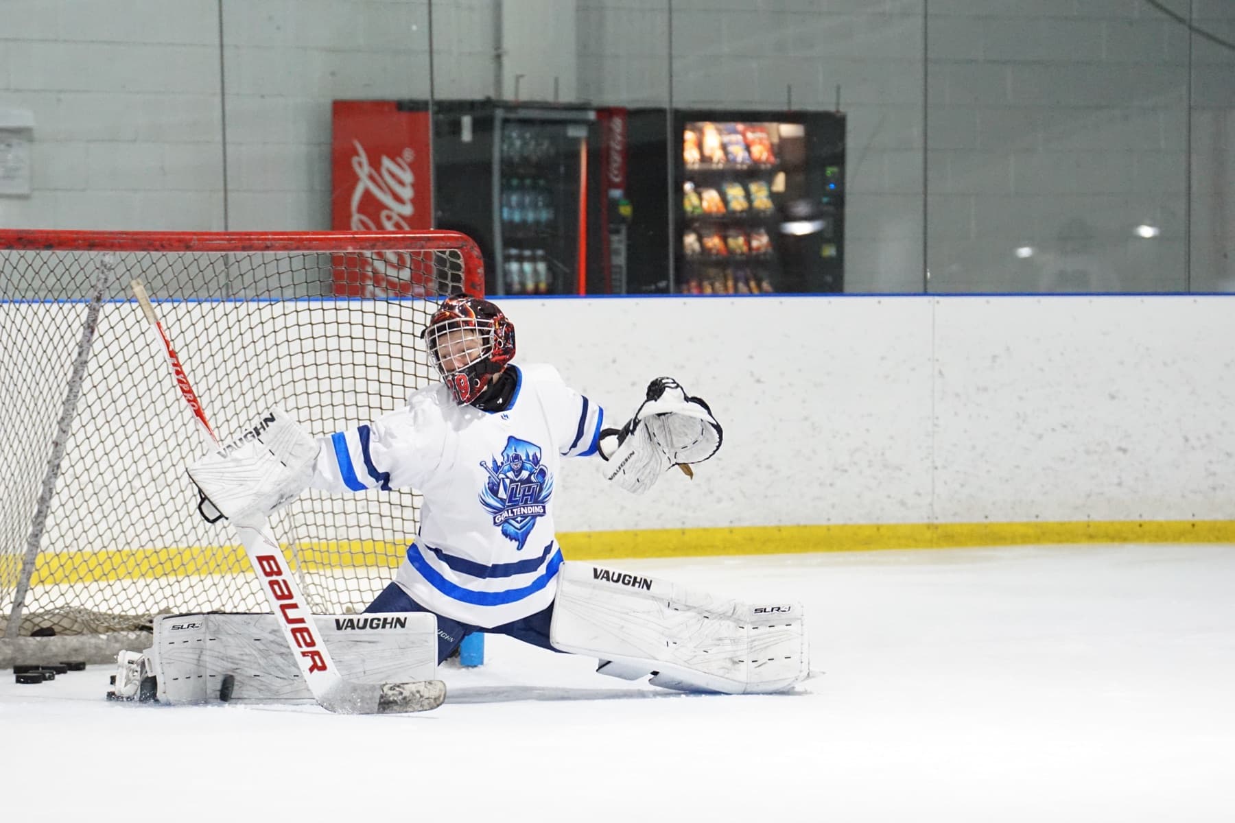 LH Goaltending goalie making a butterfly save at the net